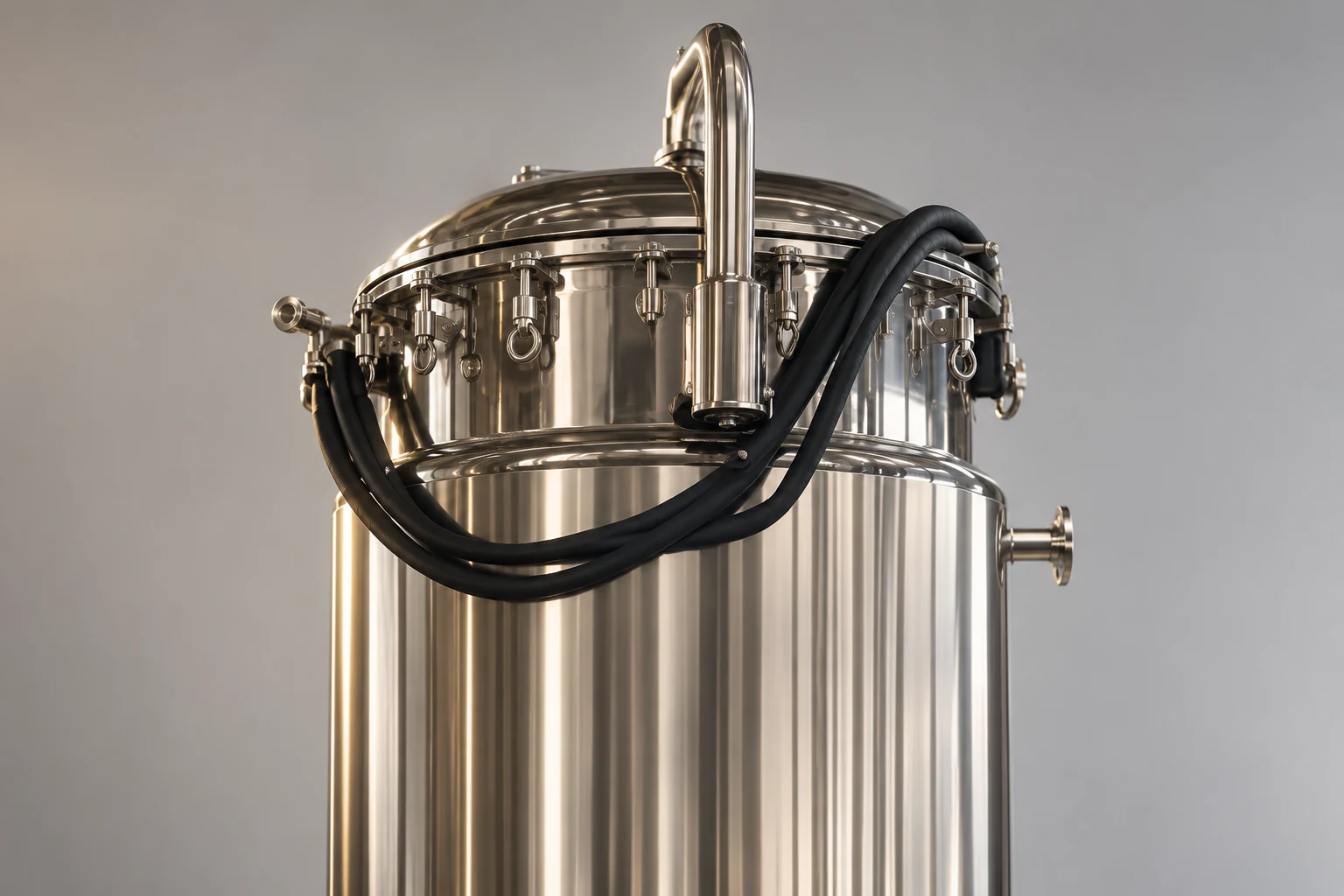 Close view of fermenter top connections and black hoses
