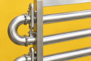 Sanitary U-return bend and adjacent tube passes against a yellow wall