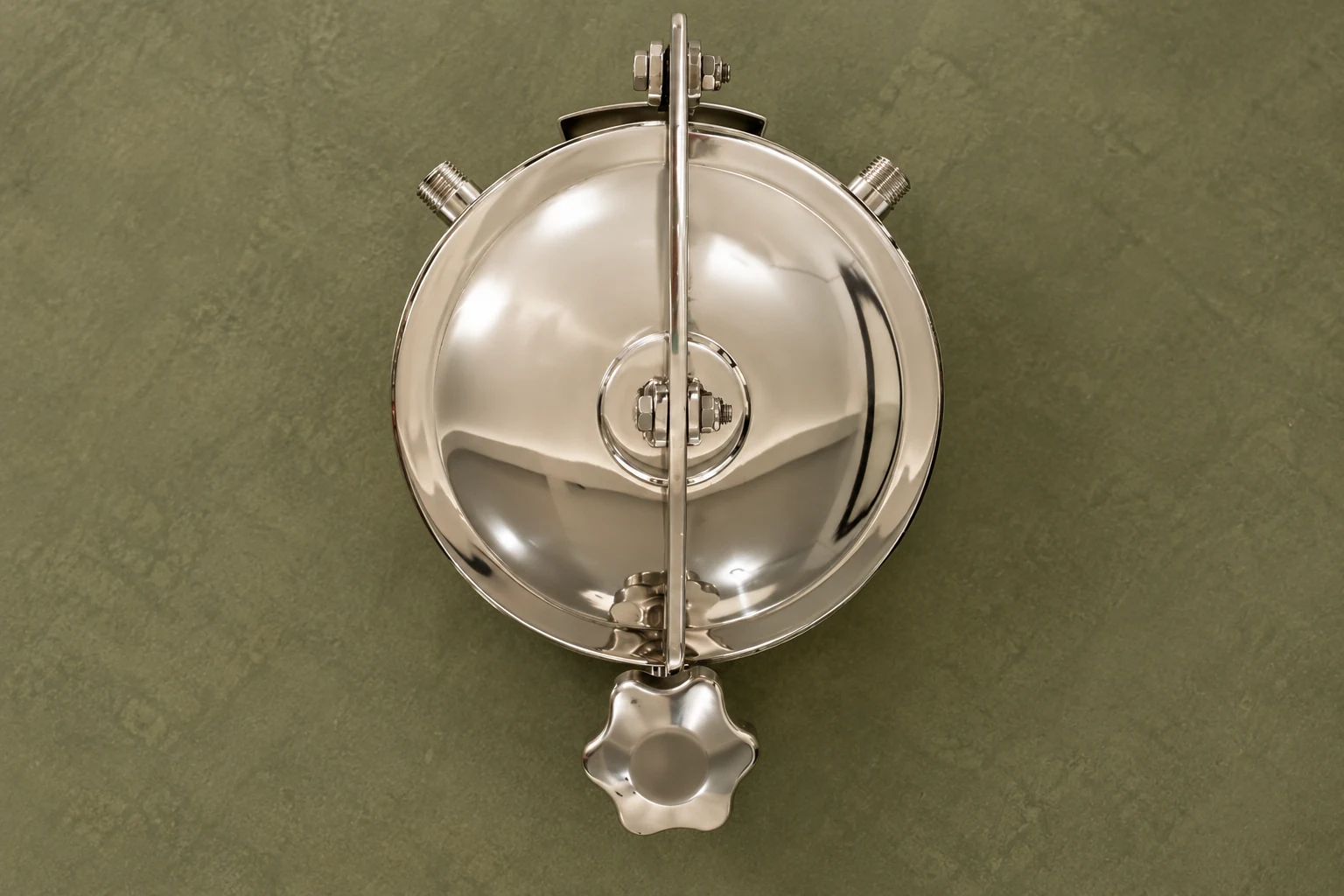Top view of a stainless tank manhole cover and operating handle