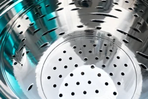 Close view of filter mounting plate openings under teal light