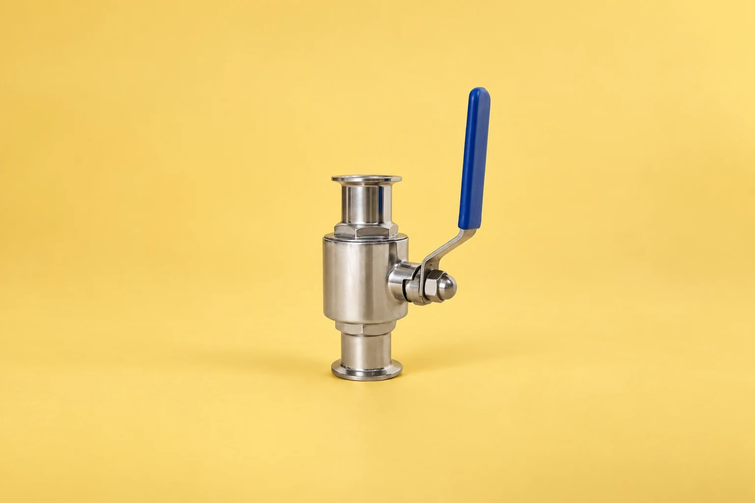 Stainless ball valve and blue handle on a yellow background